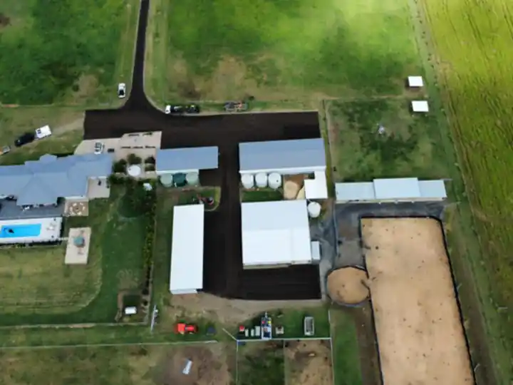 Aerial view of a new asphalt driveway and hardstand at a rural property